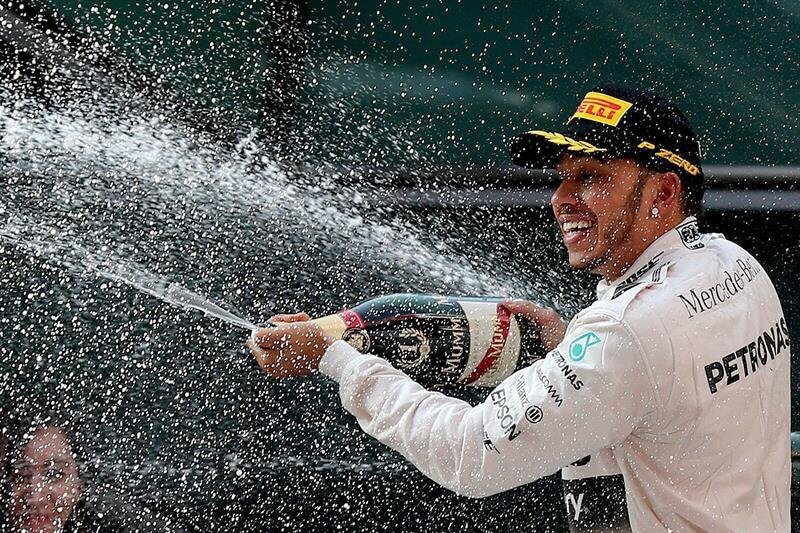 Lewis-Hamilton-som-har-bäst-Formel-1-lön-sprutar-champagne-på-prispallen